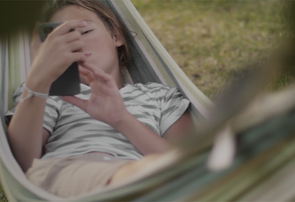 Child on swing with smartphone